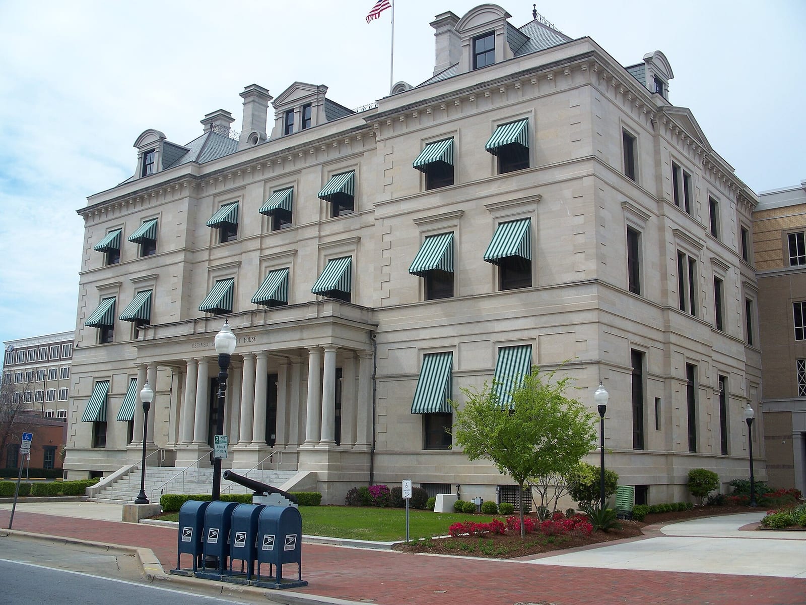 Historic Pensacola customs house with brick and stone walls and striped awnings