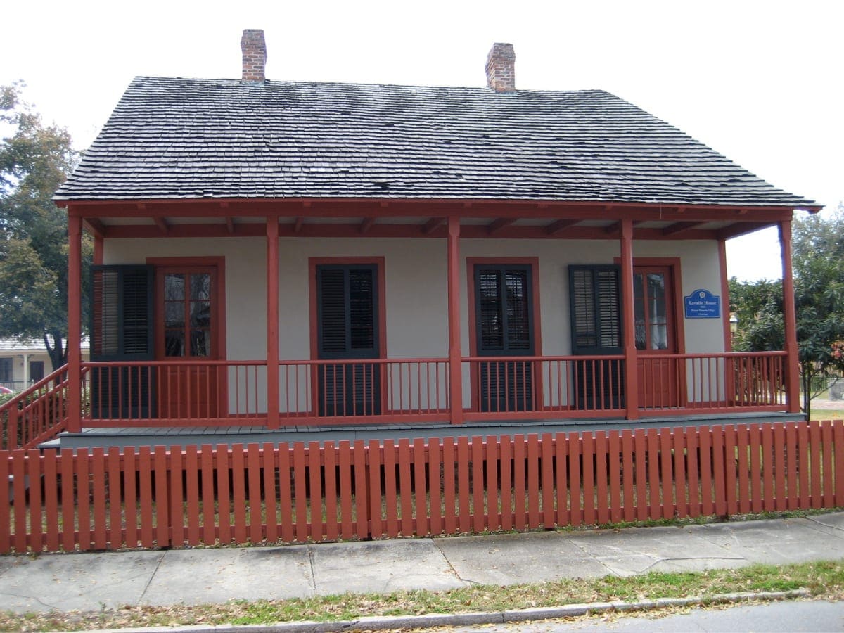 Lavalle House in Pensacola with a red porch railing, shutters and a wood-shingle roof
