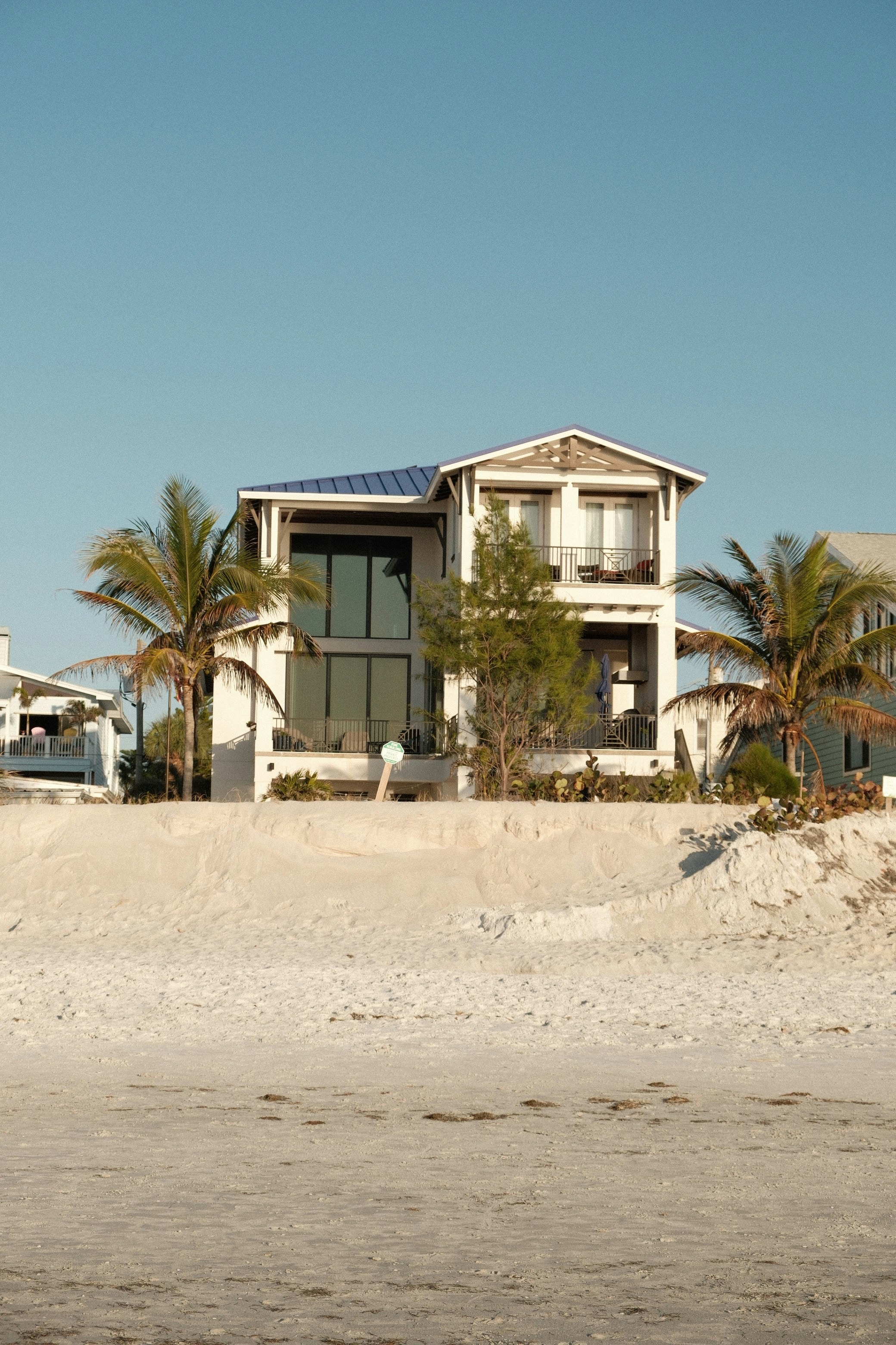 A multistory Florida beach home with balconies facing the sand. Illustrative architecture, not a current listing.