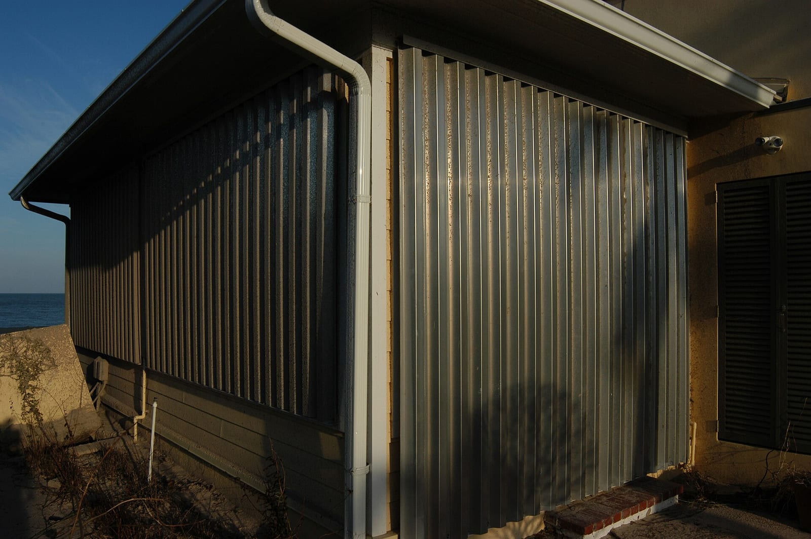 Metal storm panel protecting a window on a Florida building